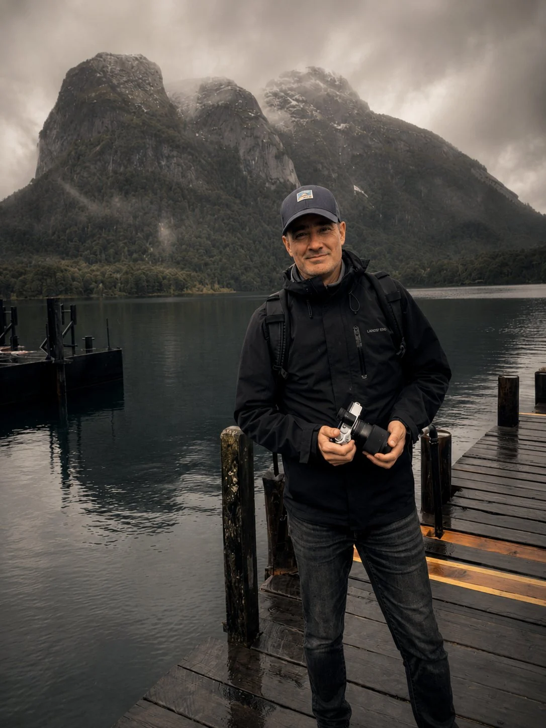 Dan Case on a dock beside a mountain lake