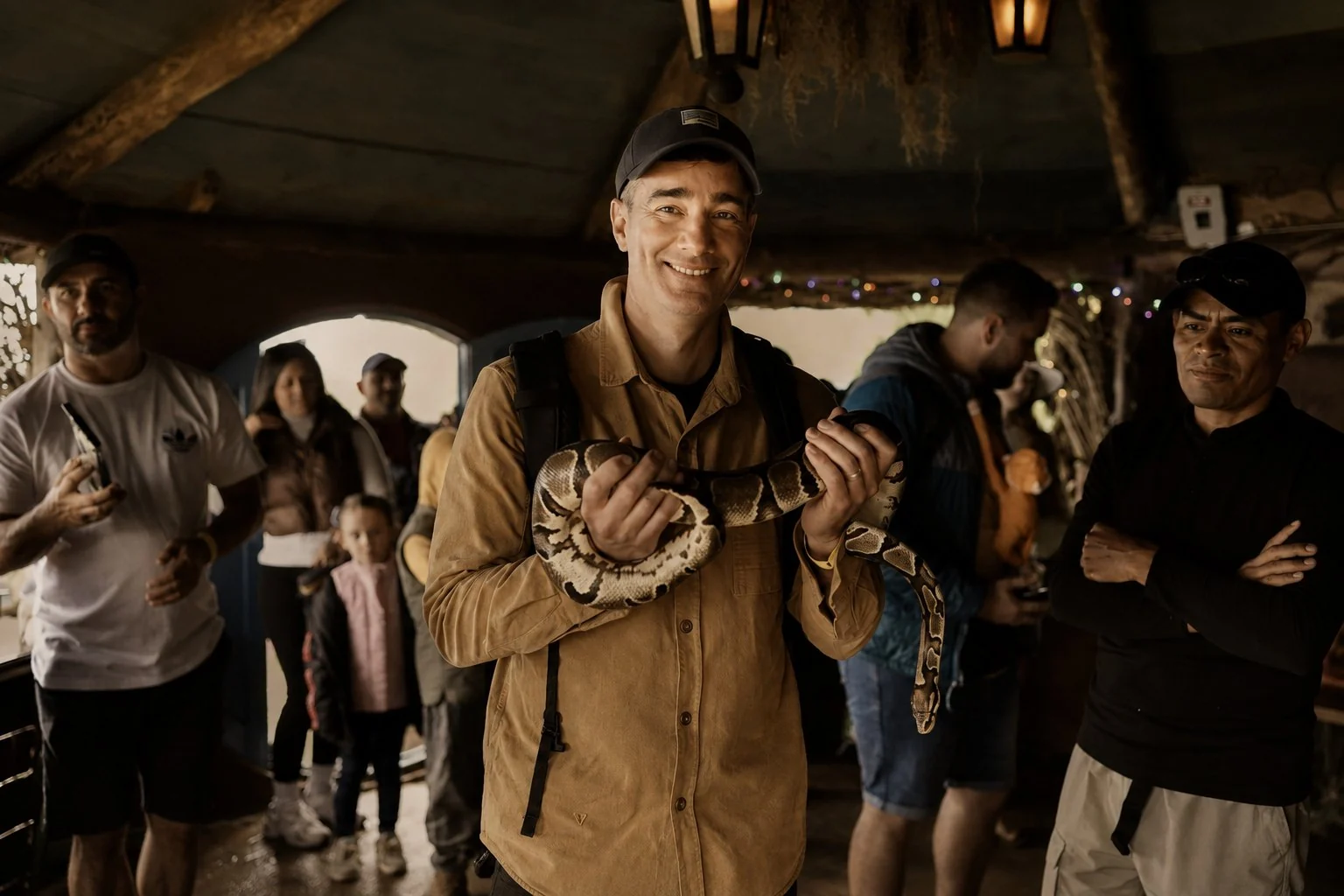 Dan Case holding a large snake during travel