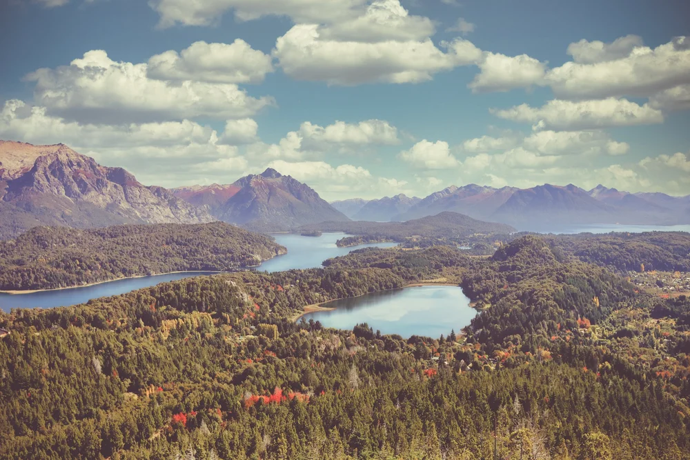 High overlook across forested lakes and mountains