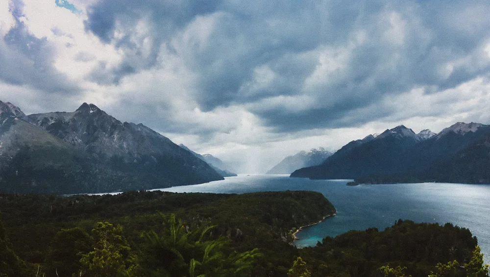 Mountain lake beneath dramatic storm clouds in Patagonia